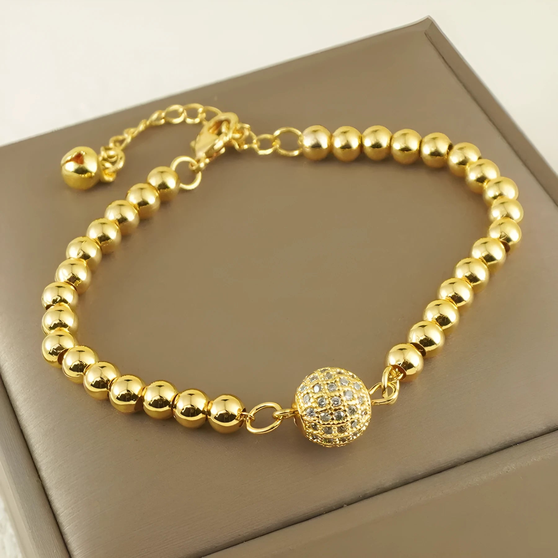 Close-up of a women's heart-shaped copper bracelet with a single round zircon stone, Arabic style.