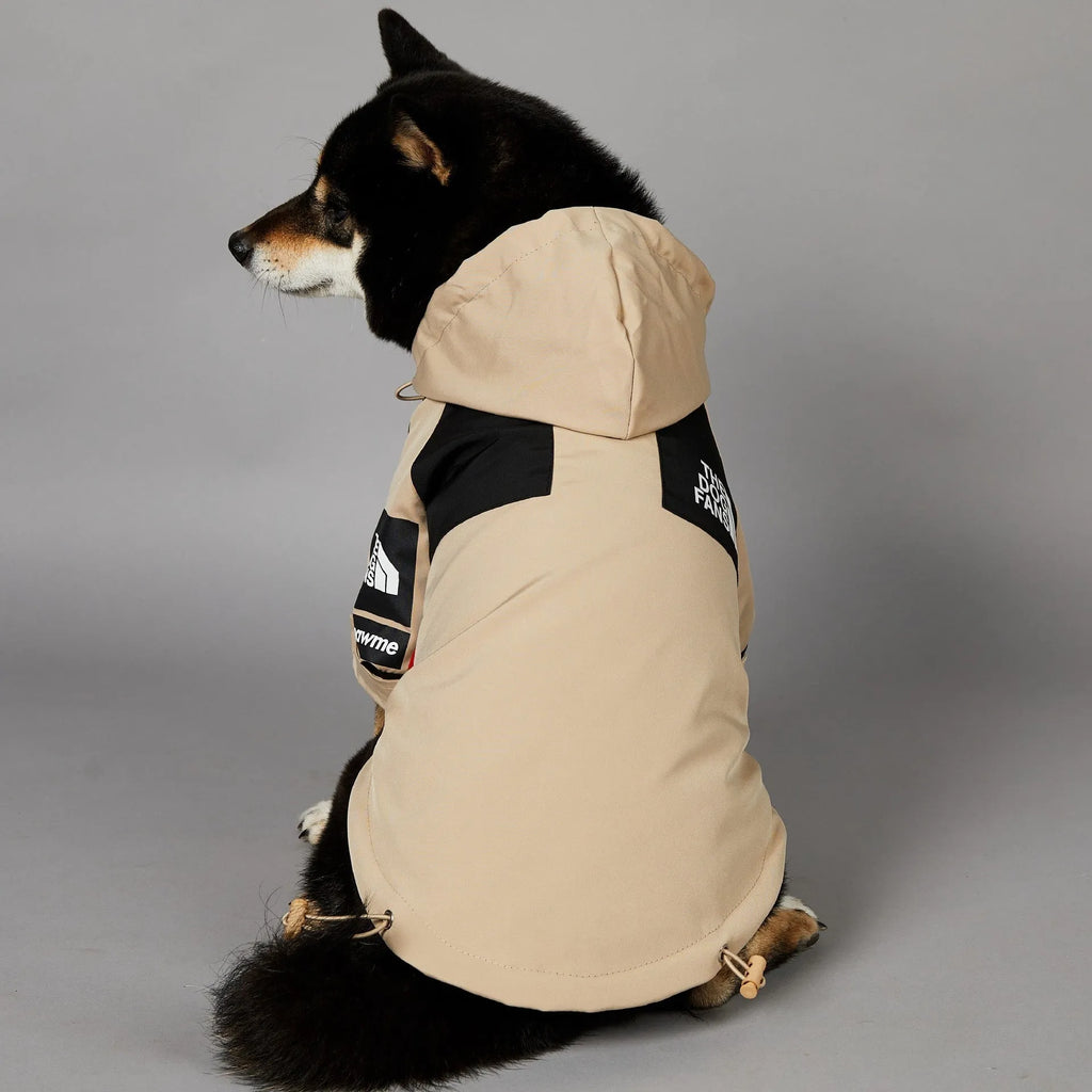 Khaki coloured polyester shell jacket for a dog on a white background.