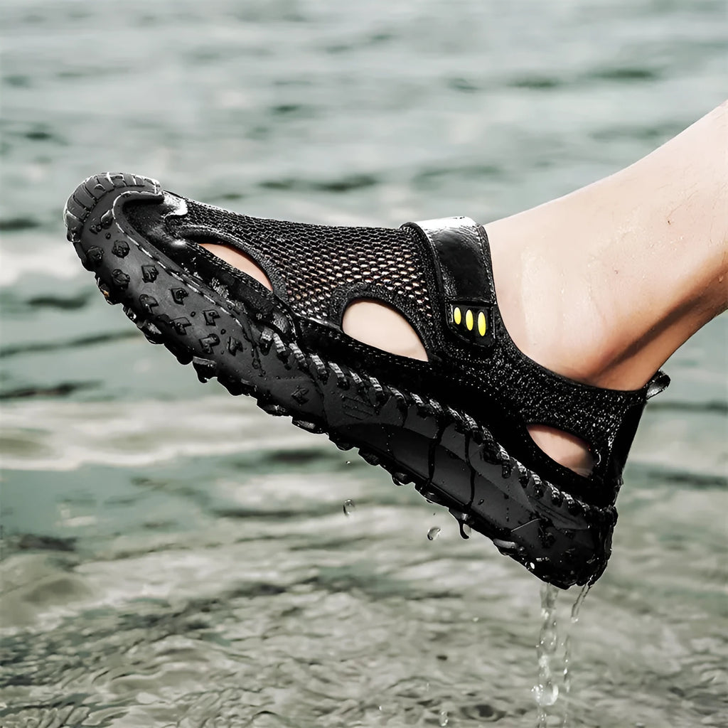 Men's black casual sandals with mesh upper and Velcro strap on a rubber sole.