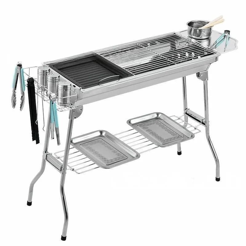 Stainless steel portable folding barbecue grill with large cooking area.