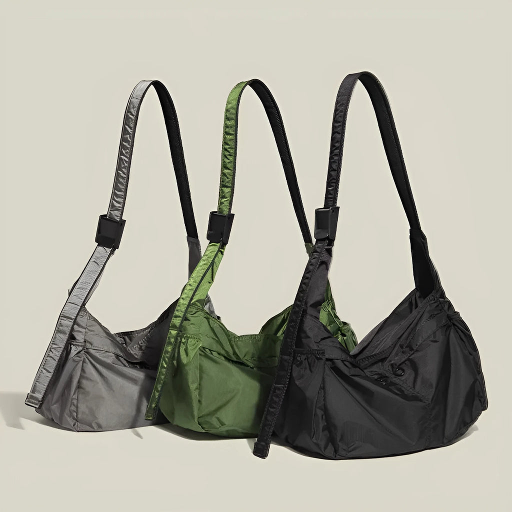 Nylon waterproof messenger bag in black with single shoulder strap and horizontal square design