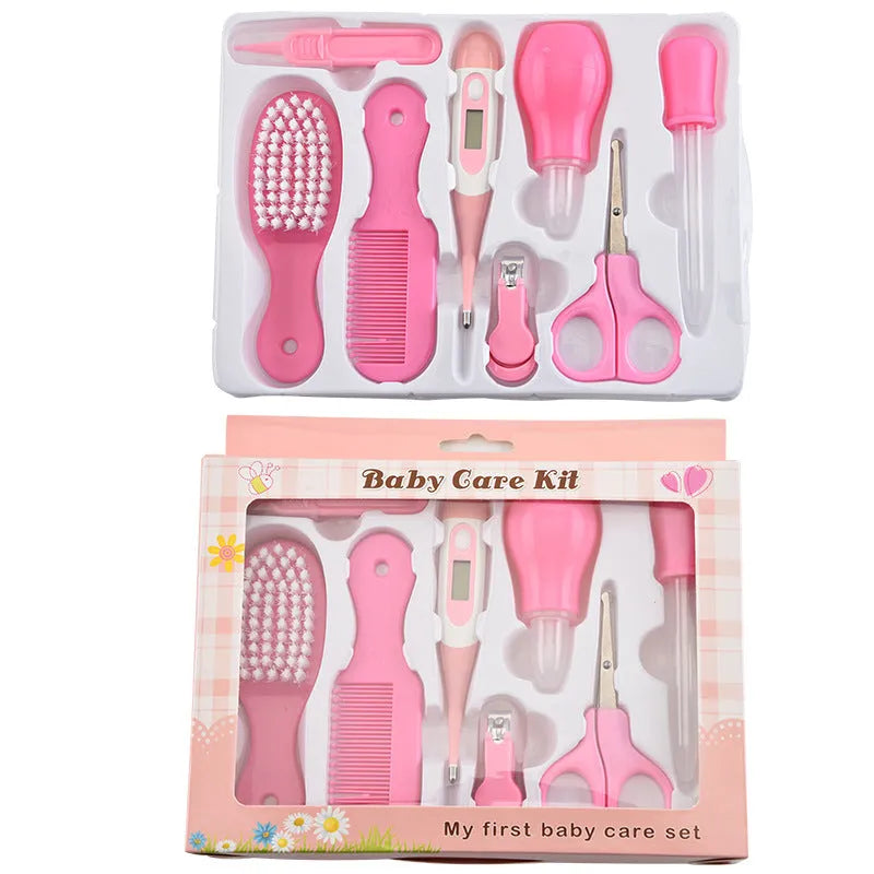 Portable baby health suit 9-piece grooming set in pink with scissors, clippers, comb and thermometer on white background