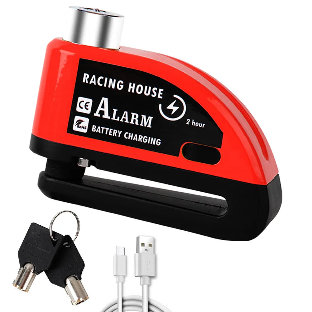 Black metal bicycle disc brake lock with red alarm button and warning cable rope on a bike disc brake