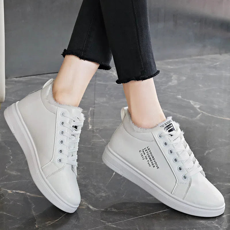 Women's flat sneakers with round toe and front lacing in black, brown, white, and pink