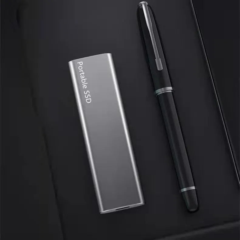 Red portable metal SSD hard drive with ultra-thin design on a grey background.