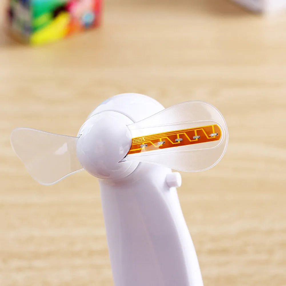 White handheld mini fan with flashing blue and red LED 'I Love You' text on a clear display panel.