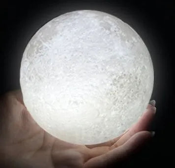 3D printed white moon lamp with textured surface on a wooden stand, showing touch ring at base