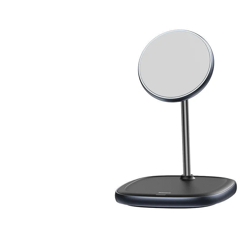 Black magnetic wireless charging stand holding an iPhone 12 upright on a desk.