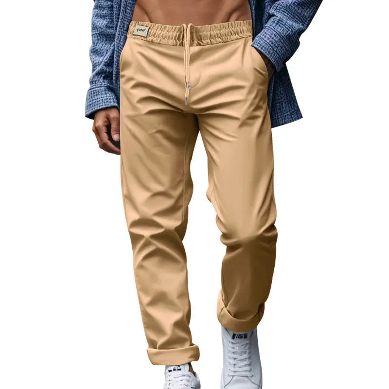 Men's loose fit drawstring trousers in solid colour Beige, side view showing straight leg and mid-waist drawstring closure.