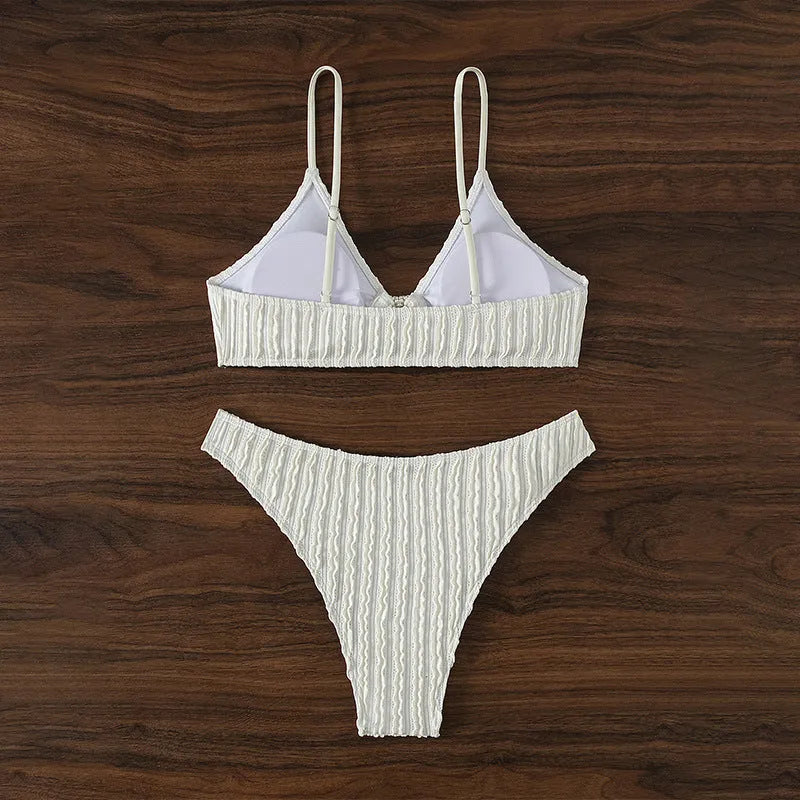 White women's V-neck swimsuit with split design for beach swimming.