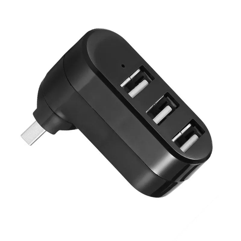 Black or white USB 2.0 four-port hub for laptop expansion on a desk.