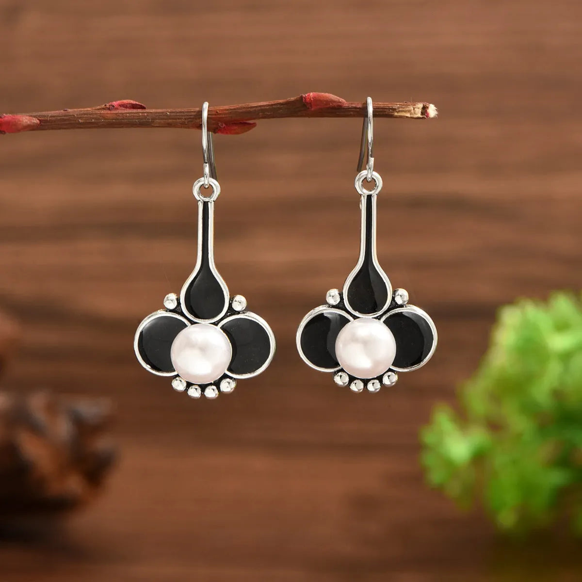 A pair of silver retro fashion creative earrings for women on a white background.