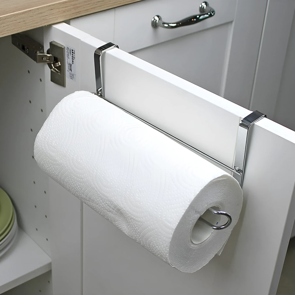 Silver stainless steel kitchen towel rack mounted on a cabinet door holding a paper towel roll.