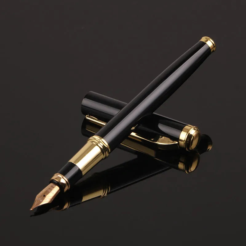 Red and black metal ballpoint pen with a 0.5mm stainless steel nib on a notepad.