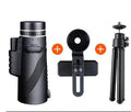 Black 40x60 monocular telescope with mobile phone attachment for photography on a table.