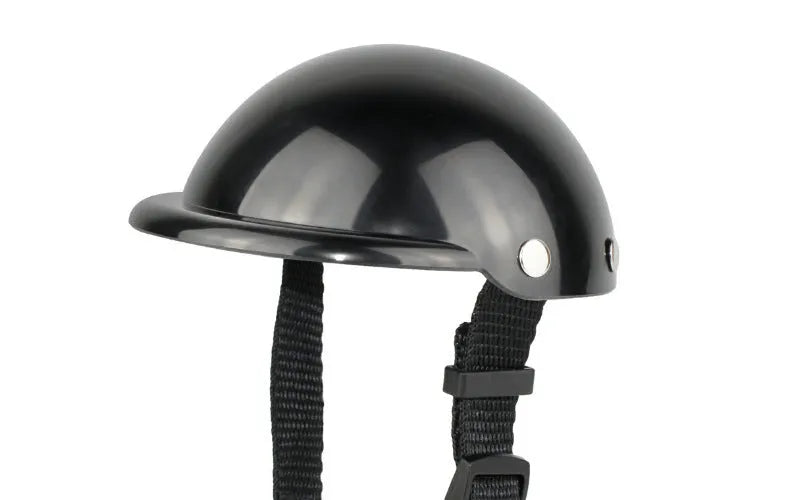 Black pet motorcycle helmet for dog or cat with adjustable strap on a bicycle