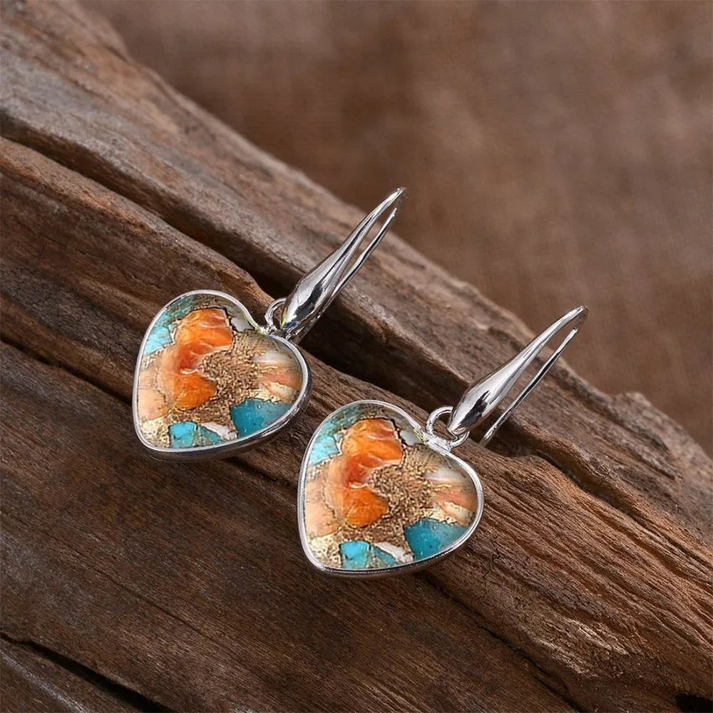 Silver alloy vintage bohemian water droplet pendant drop earrings on light background