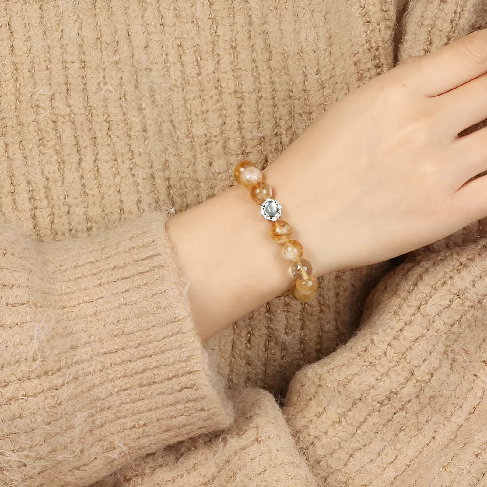 Citrine colour crystal bracelet with 10mm geometric beads on a wrist.
