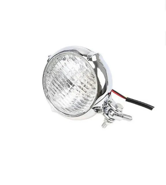 Black retro motorcycle headlight with cast aluminium housing and yellow halogen bulb, shown from the front.