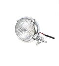Black cast aluminium Harley Davidson style motorcycle headlight with yellow halogen bulb.