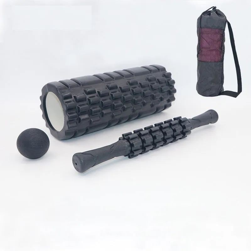 Black 33cm long foam roller massage stick with gear bar design on a grey background.