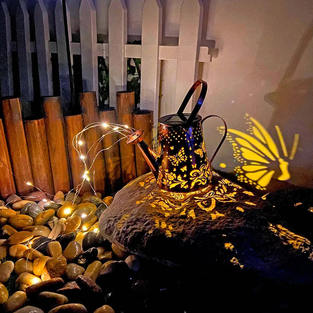 Solar-powered iron garden lamp with tapered butterfly design in warm white.