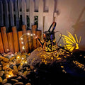 Solar-powered iron garden lamp with a decorative tapered butterfly design.