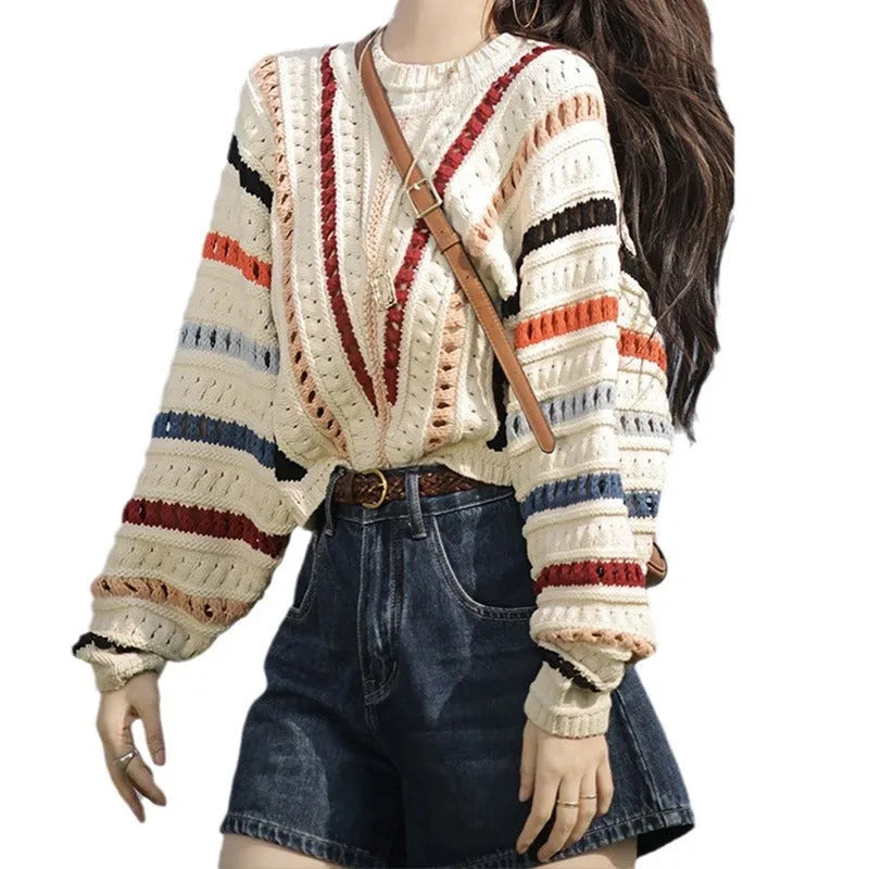 Retro rainbow striped pullover sweater with batwing sleeves on a hanger.