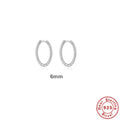 Sterling silver twisted string round hoop earrings in gold colour, showing geometric detail.