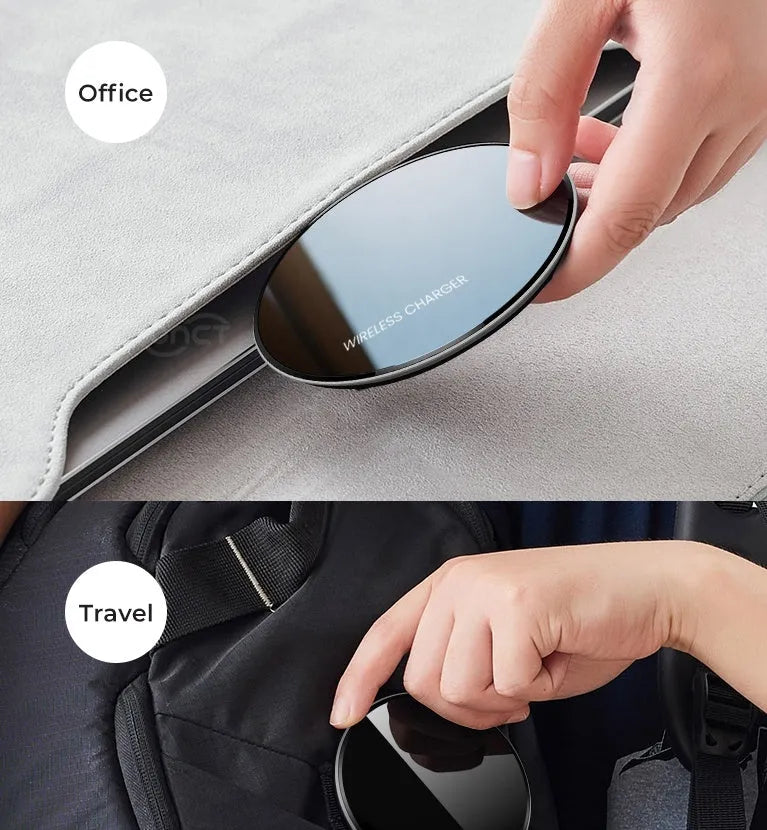 Black QI wireless charging pad on a desk, showing its non-slip silicone base.
