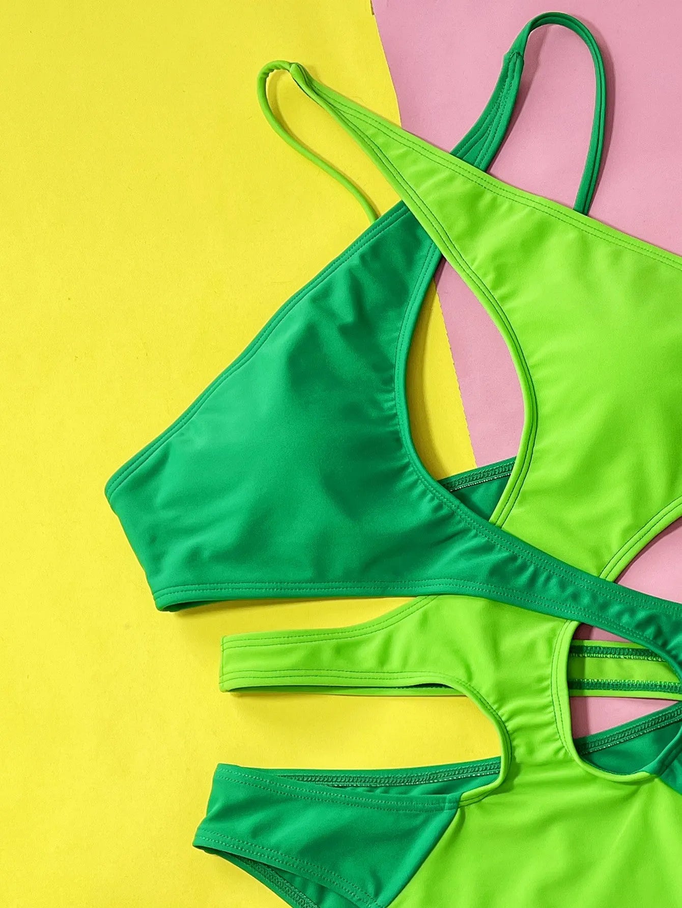 Solid green women's one-piece nylon swimsuit on a hanger