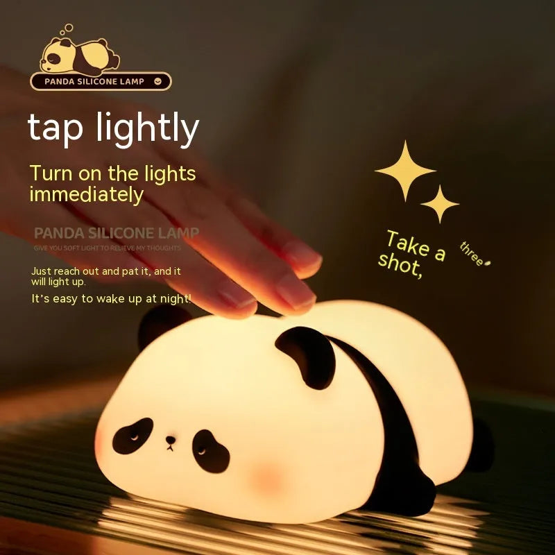 Cartoon panda silicone night light with USB charging cable on wooden surface