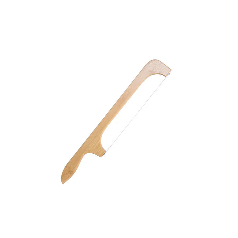 Wooden serrated bread knife with 40cm blade on a cutting board next to a loaf of bread