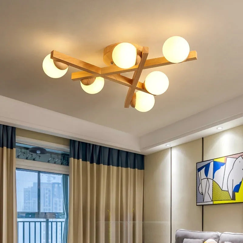 Modern Nordic-style wooden ceiling light fixture with three adjustable lamp heads mounted on a living room ceiling.