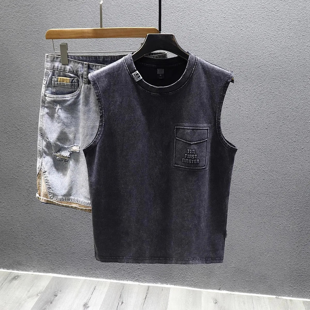 Women's loose fit cotton sleeveless vest in white on a hanger, showing straight hem and solid colour.