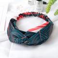 Red cloth headband with banana leaf and cross hair decorative pattern.