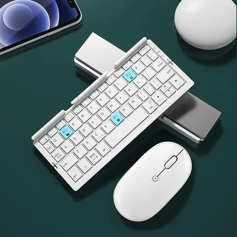 Silver white folding Bluetooth keyboard open with phone in stand next to closed black grey version