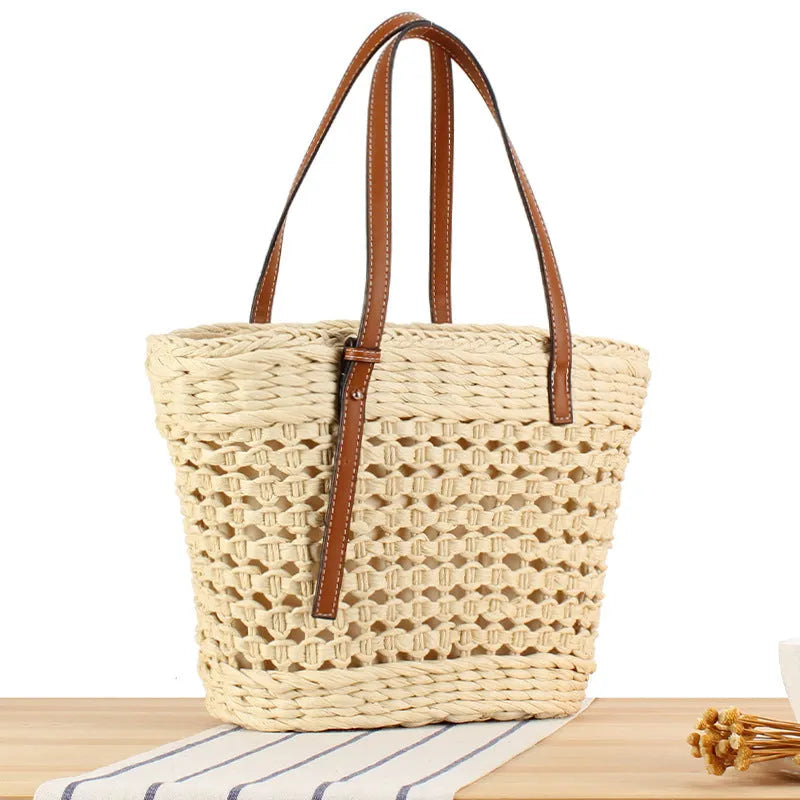 Beige paper string woven large capacity shoulder bag showing horizontal square shape and adjustable strap.