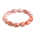 Natural cherry agate bracelet with geometric 10x14mm barrel beads and ruyi details on a wrist.
