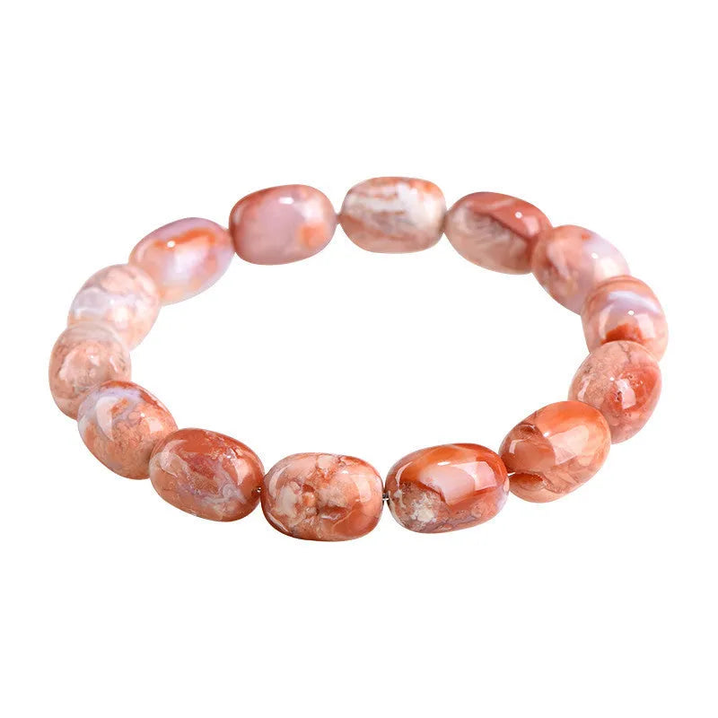 Natural cherry agate bracelet with geometric 10x14mm barrel beads and ruyi details on a wrist.