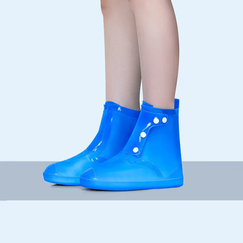 White high top PVC reusable water resistant shoe covers for women with anti-skid soles.