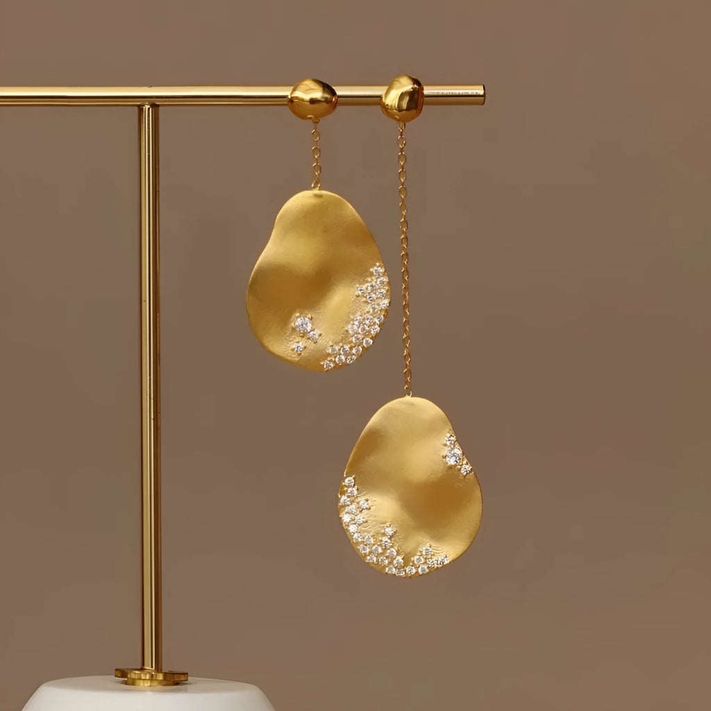 Asymmetric floral earrings with zircon crystals in gold or silver colour options