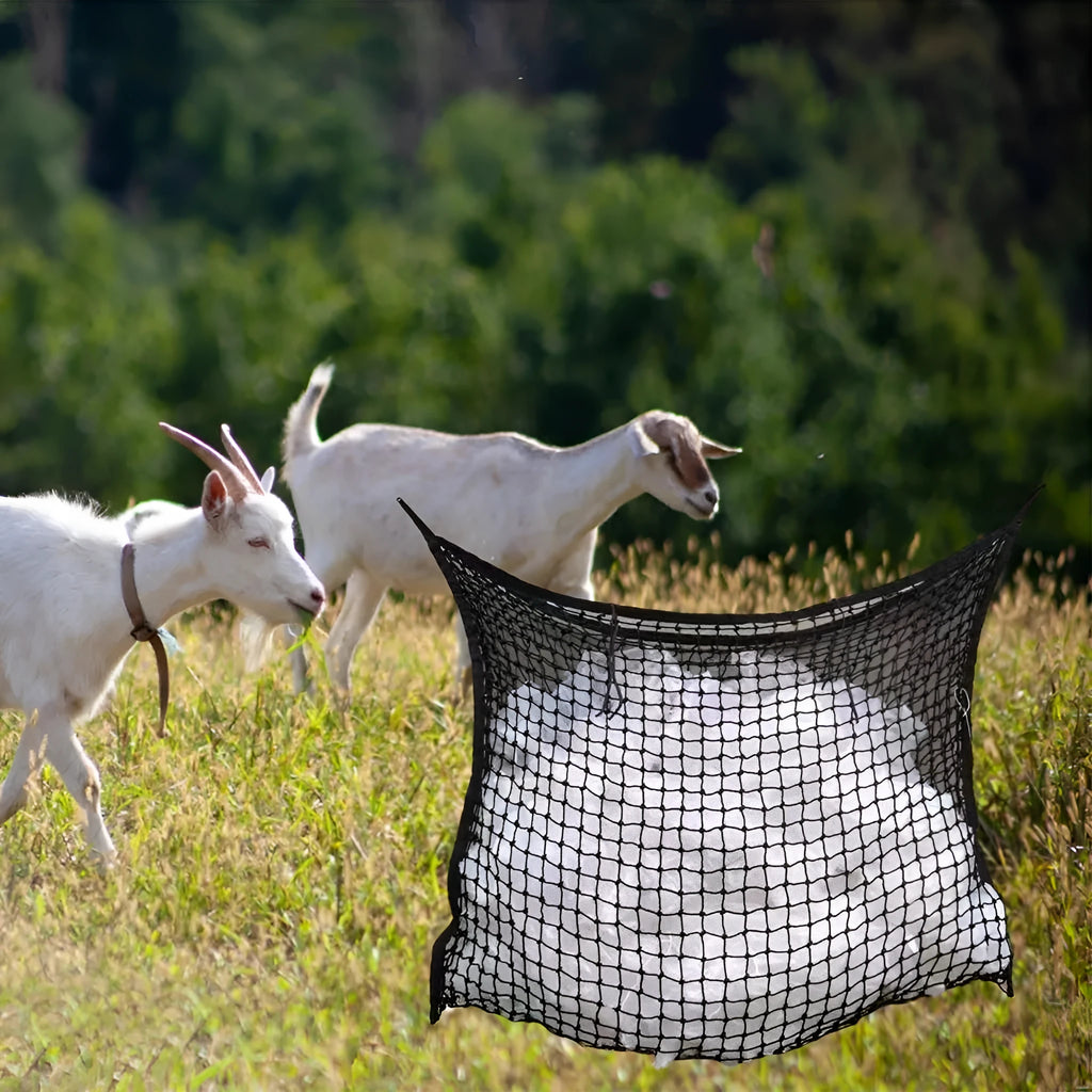 Black woven grid horse feeding bag hanging, filled with hay.