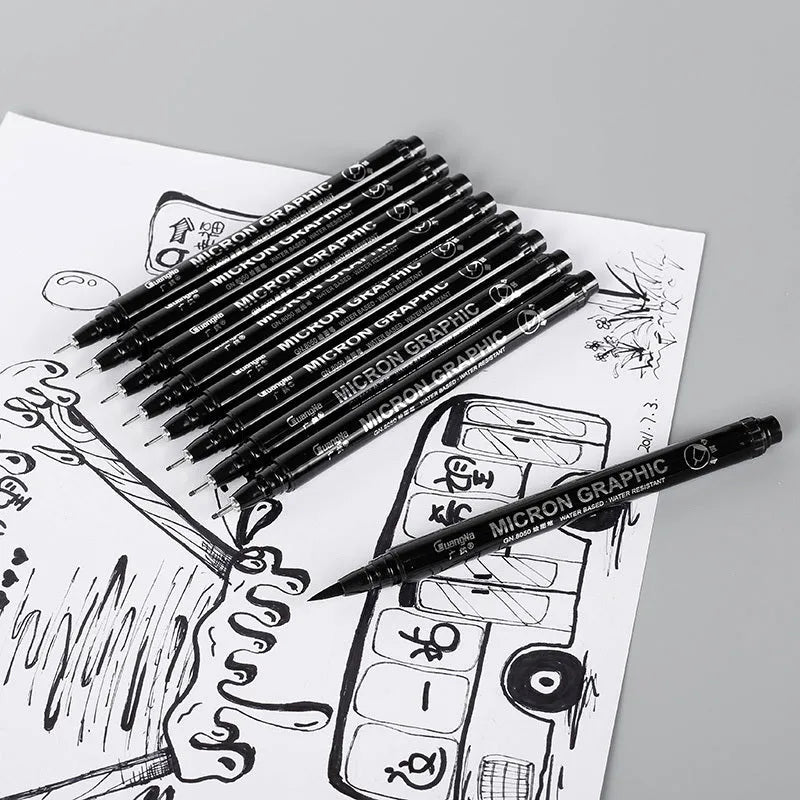 Set of 12 black comic drawing pens with various nib sizes stored in a fabric organiser bag.