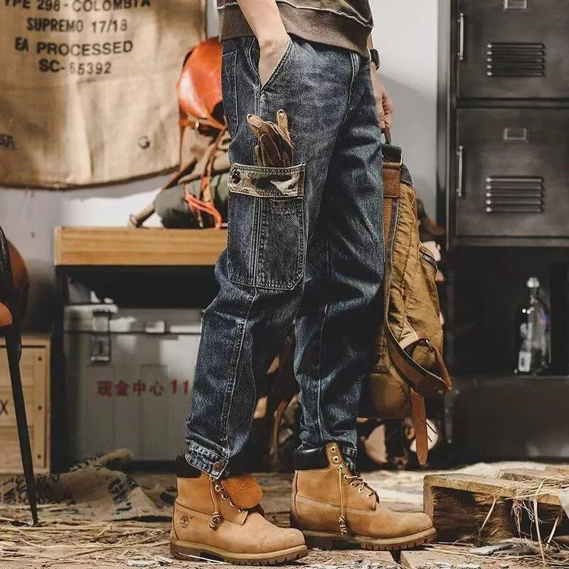 Men's loose blue denim cargo jeans with heavy distressed finish, mid waist, button fly