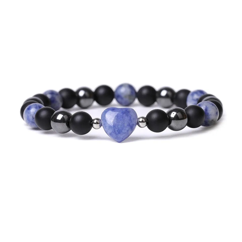Hand-cut peach heart stone bracelet in geometric design with planetary elements