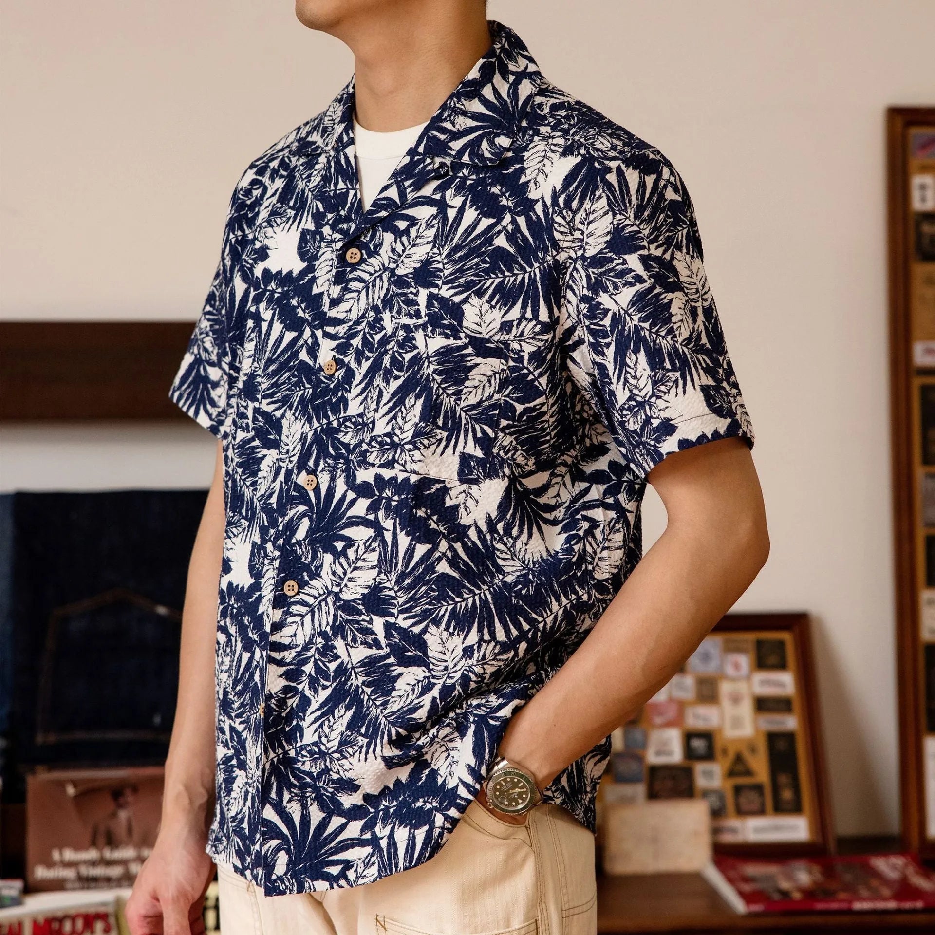 Man wearing a vintage floral print seersucker shirt with a Cuban collar in a loose, casual fit.