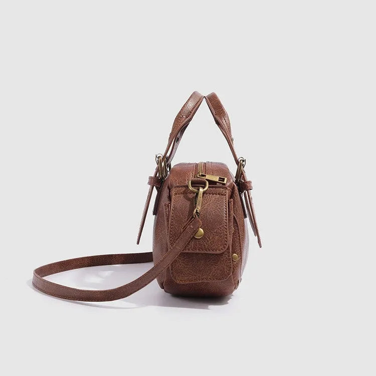 Brown artificial leather motorcycle bag with single shoulder crossbody strap and horizontal square retro shape