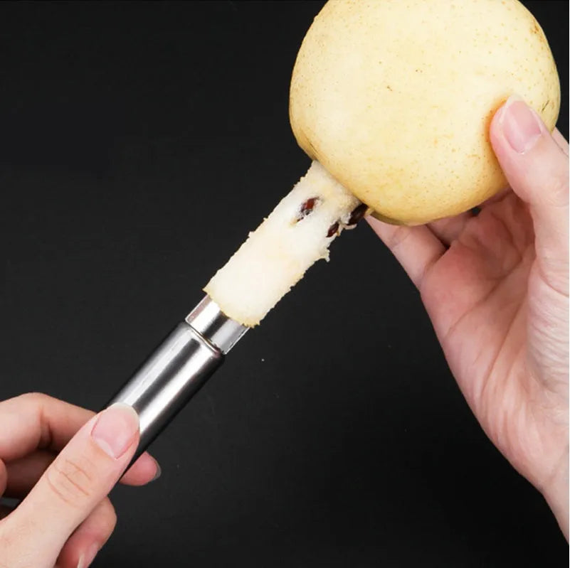 Stainless steel pineapple corer slicer with coloured ABS handle on a kitchen counter.