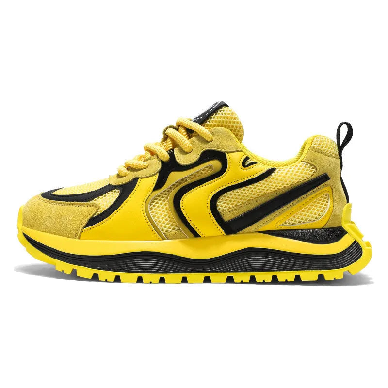 Men's casual sneaker in synthetic leather and mesh, showing round toe and lace-up front.